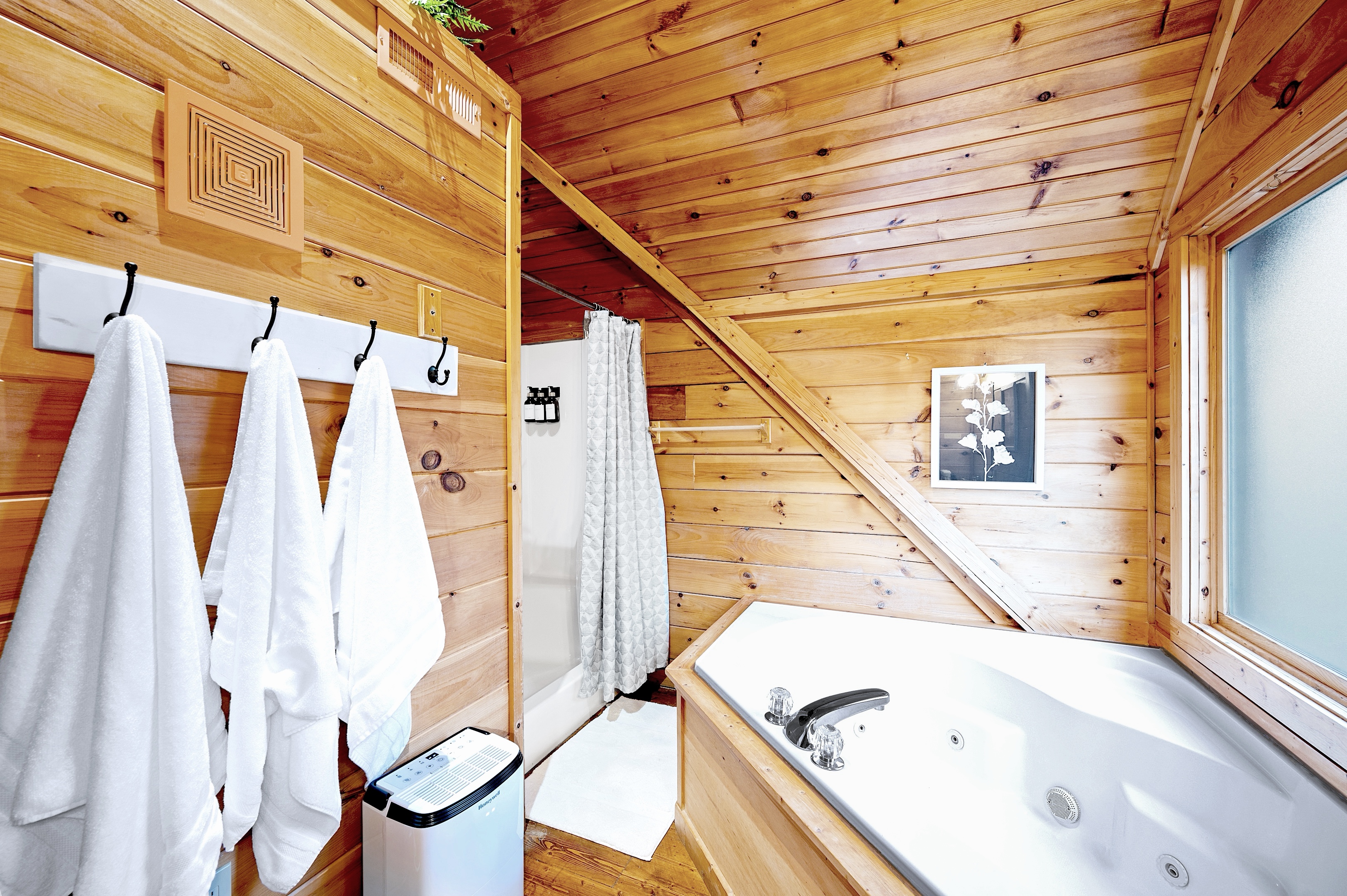 Bathroom with jacuzzi tub, walk-in shower, and fresh towels