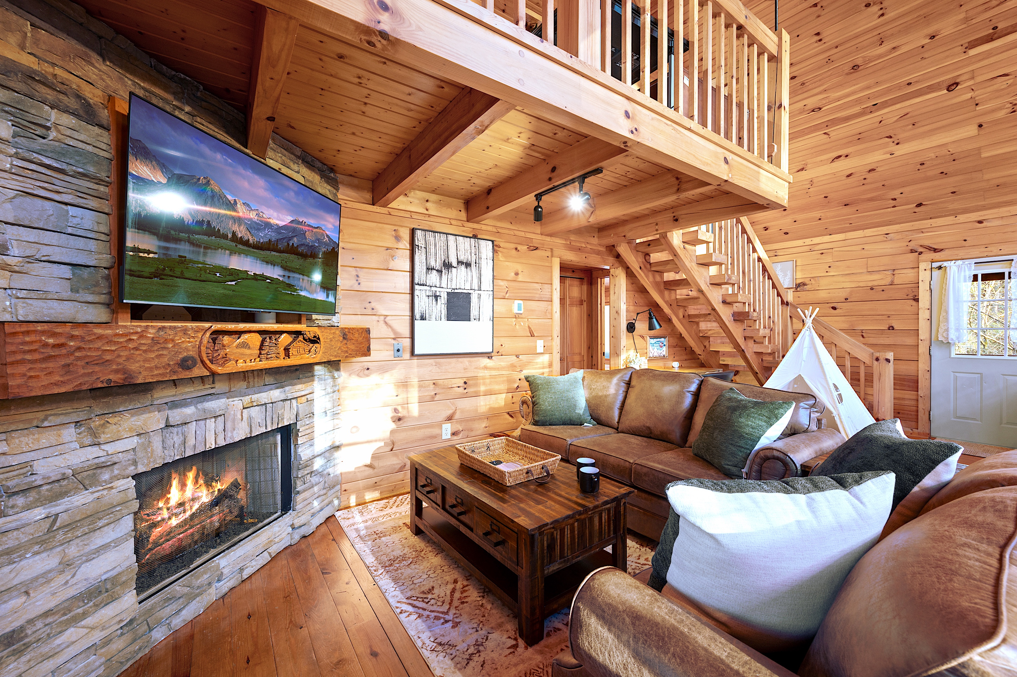 Cozy cabin interior with stone fireplace and leather sofa