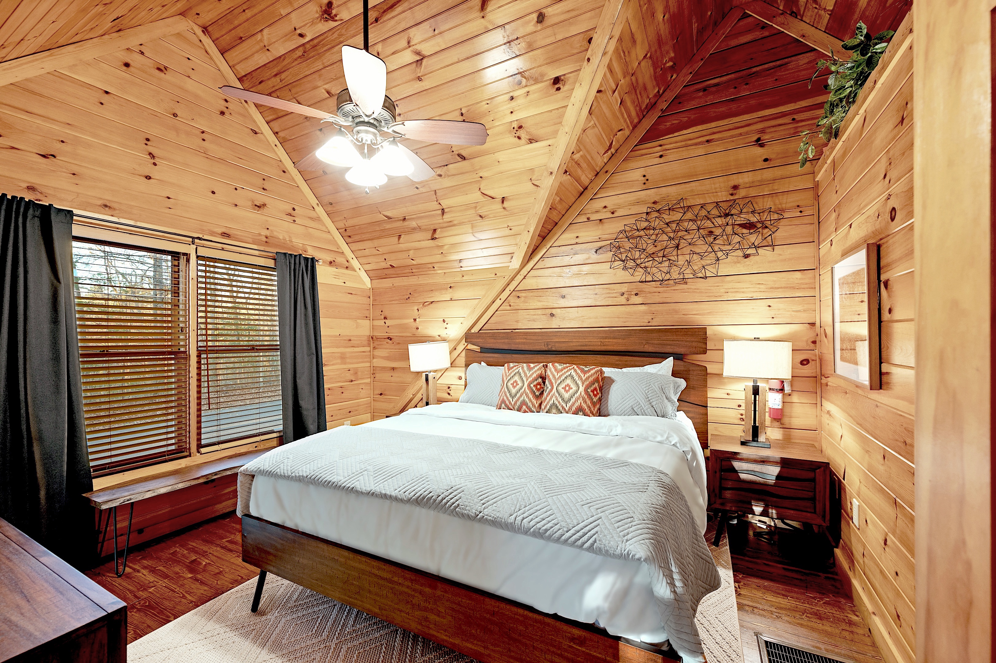 Cozy second bedroom with vaulted ceiling and modern decor